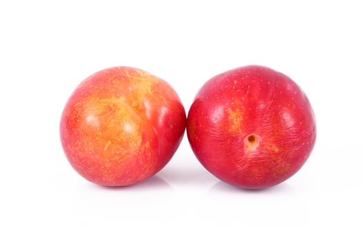 fresh plums on white background