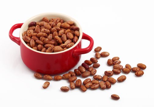 dry beans in pot on white background