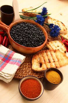 dry legumes in rustic dish on wooden table