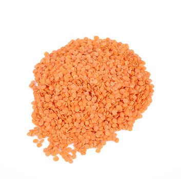 dry orange lentils on white background