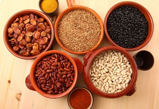 dry legumes in rustic dish on wooden table