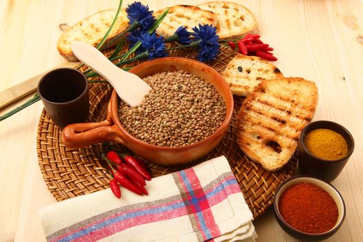 dry lentils in rustic dish on wooden table