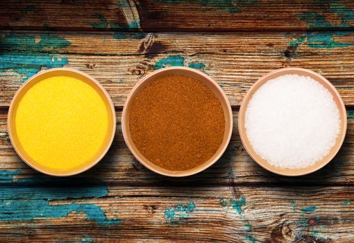 bowls with salt and pepper on dark background