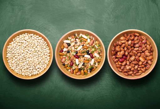 bowls with beans on green background