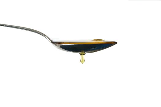 olive oil on spoon on white background