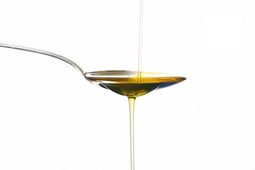 olive oil on spoon on white background