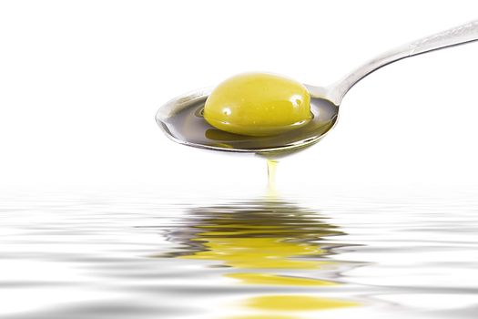 olive oil on spoon on white background