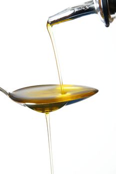 olive oil on spoon on white background