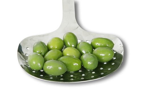 green olive in ladle on white background