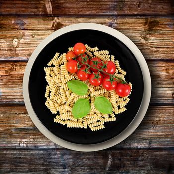 black dish with raw italian pasta and ingredients