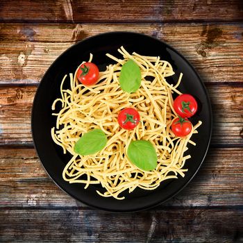 black dish with raw italian pasta and ingredients