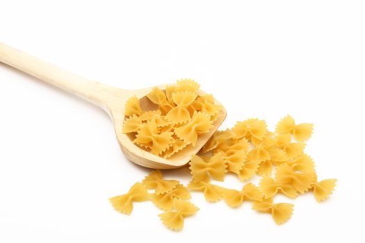 wood spoon with italian raw pasta on white background