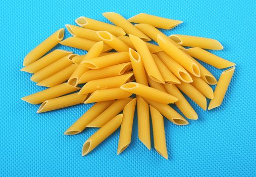 italian raw pasta on blue  background