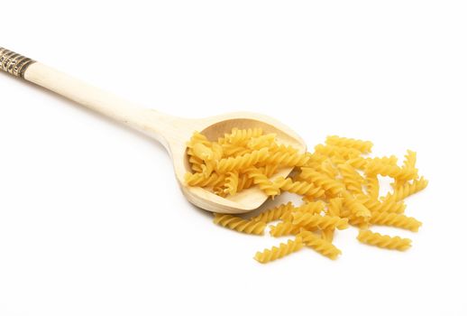 wood spoon with italian raw pasta on white background