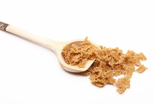 wood spoon with italian raw pasta on white background