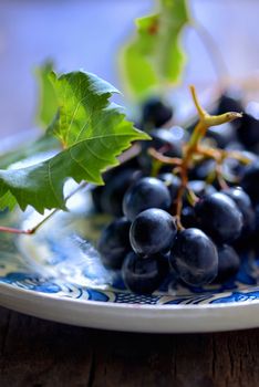 Grapes on a rustic clay plate