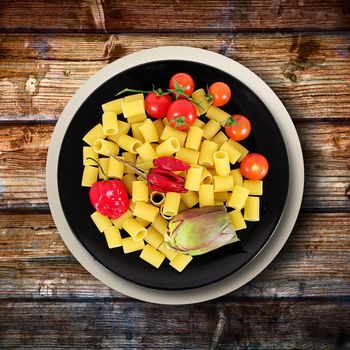 black dish with raw italian pasta and ingredients