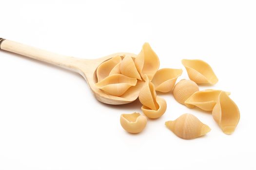 wood spoon with italian raw pasta on white background