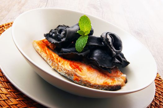 original italian ravioli with squid ink and salmon