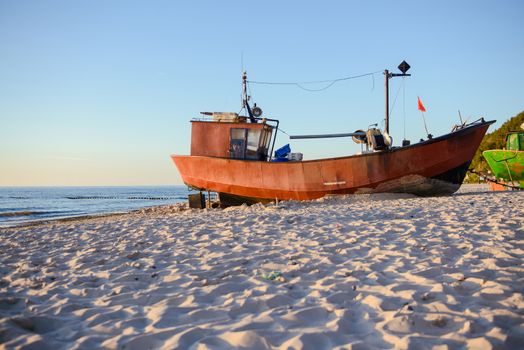fisherman boats at sunrise time on the beach in summer