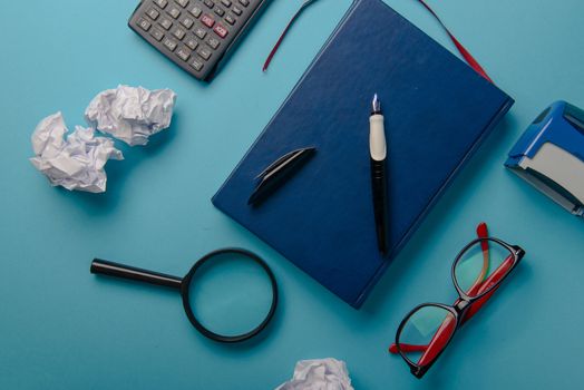 Desk with Tools and Notebook office desk on blue background