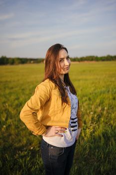 Happy young girl enjoying the beauty of sunny spring day.