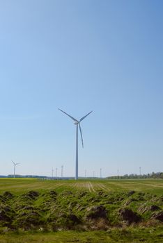 Bright blue sky moving and wind turbine.