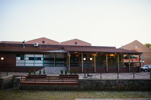 a riverside bar building in town at dusk