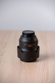Closeup of a photographic lens on wooden table
