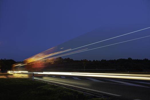 Truck light trails on highway. Art image . Long exposure photo taken on a highway.