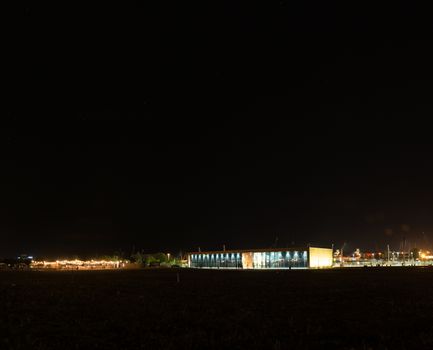 Szczecin. Night view from across the river to the illuminated historic center. Odra river. Chrobry embankments in Szczecin