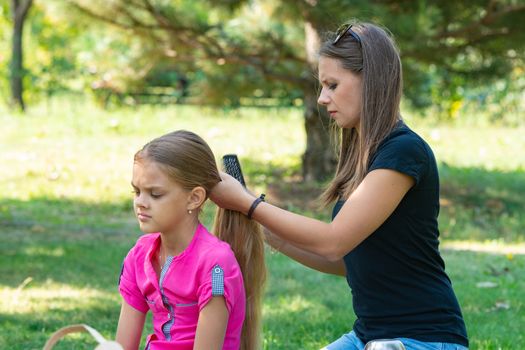 Girl combing hair girl