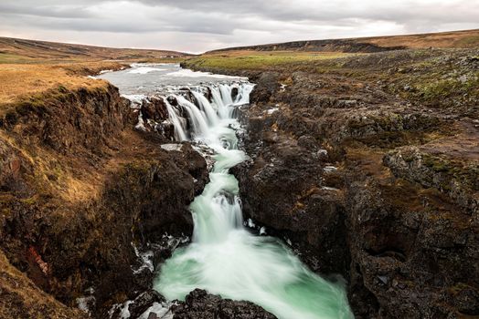 Kolugljufur waterfall in Iceland in a cloudy day