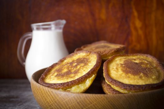 Hash browns in a wooden plate on a vintage table