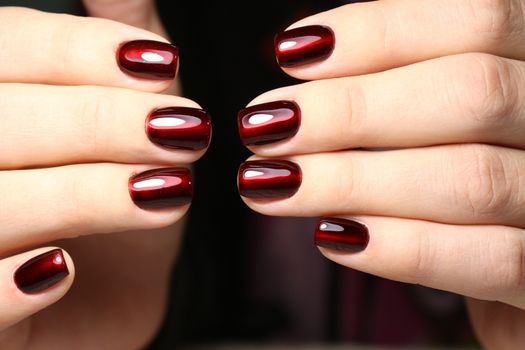 Closeup photo of a beautiful female hands with elegant manicure and diamond rings.