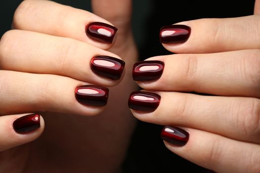 Closeup photo of a beautiful female hands with elegant manicure and diamond rings.