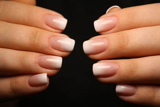 Amazing natural nails. Women's hands with clean manicure. Gel polish applied.