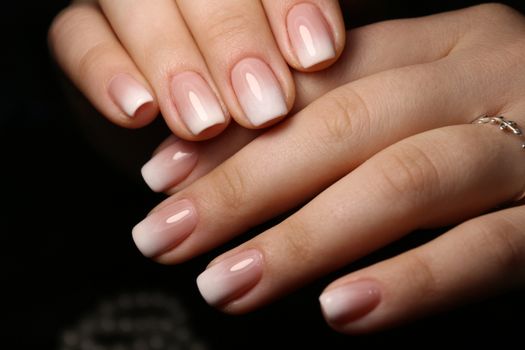 Amazing natural nails. Women's hands with clean manicure. Gel polish applied.