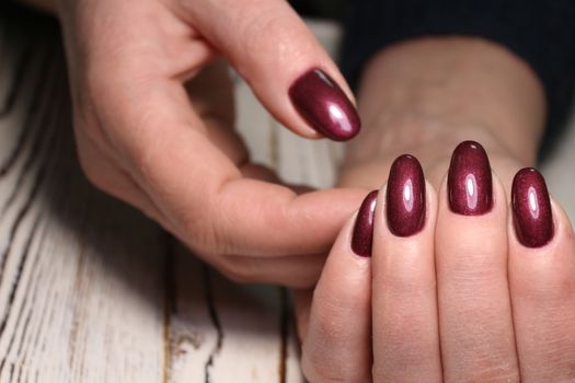 Closeup photo of a beautiful female hands with elegant manicure and diamond rings.