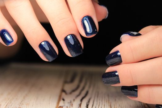 glamorous beautiful manicure on a trendy texture