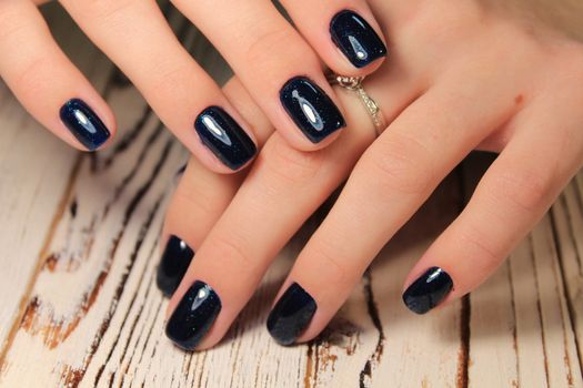 glamorous beautiful manicure on a trendy texture