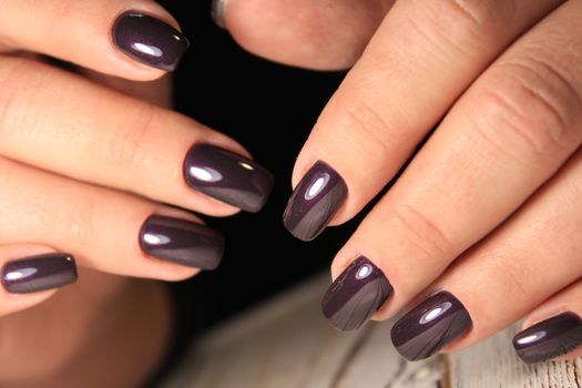 sexy gray manicure on a trendy texture background