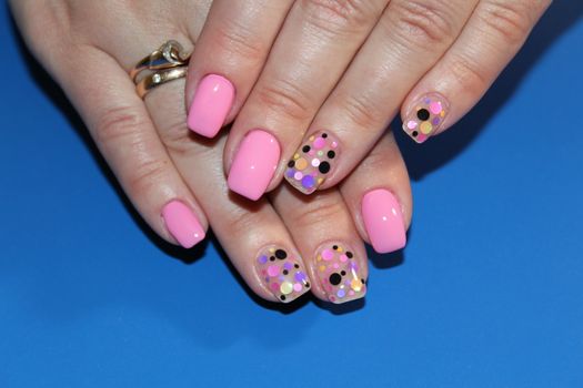 Multi-colored pastel manicure combined tone on tone with a striped background.Nail art.