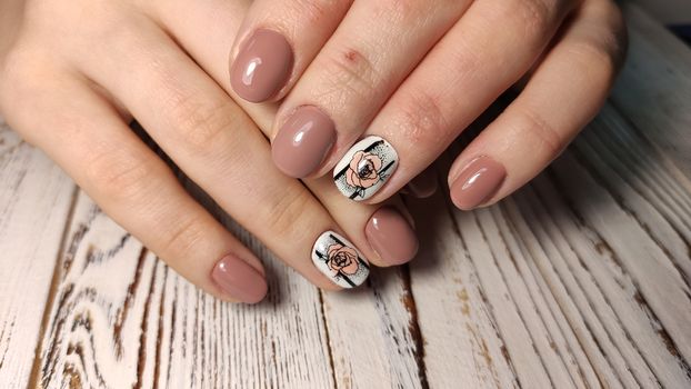 Hands with long artificial manicured nails colored with red nail polish