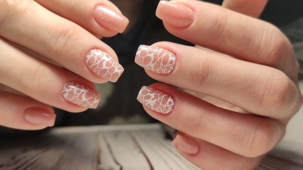 Hands with long artificial manicured nails colored with red nail polish