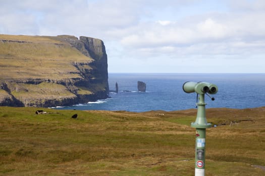 Binoculars directed to the sea stack near Eidi, Faroe Islands