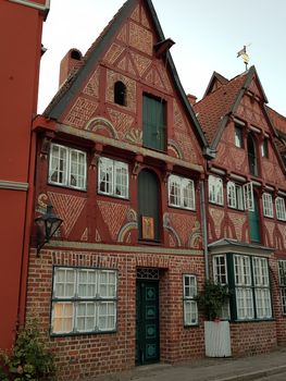 Half-timbered red brick houses near the river on the old harbor Lueneburg, Germany