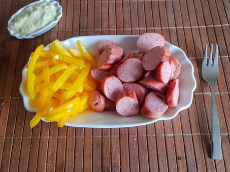 Viennese sausages with yellow peppers cut into strips as French fries substitutes. Low carb food
