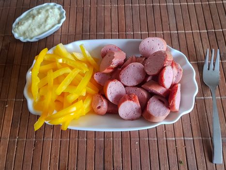 Viennese sausages with yellow peppers cut into strips as French fries substitutes. Low carb food