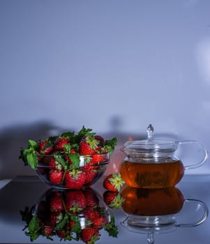 still life with Fruit tea with strawberries on a glass table